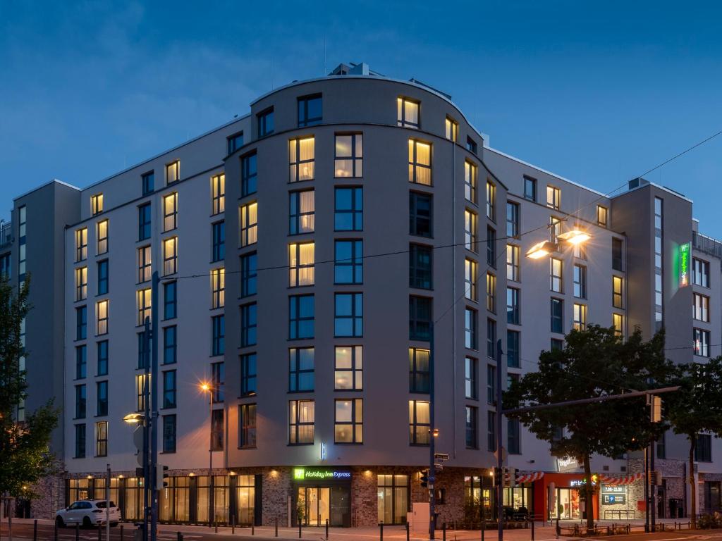 a building on a city street at night at Holiday Inn Express - Offenbach by IHG in Offenbach