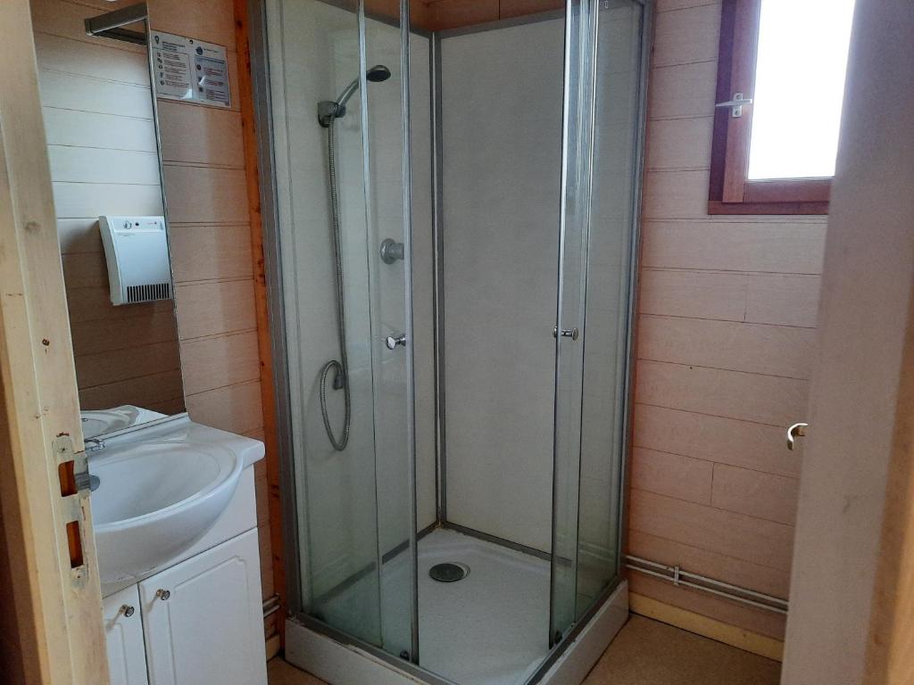 a bathroom with a shower and a sink at Camping de la Bageasse in Brioude