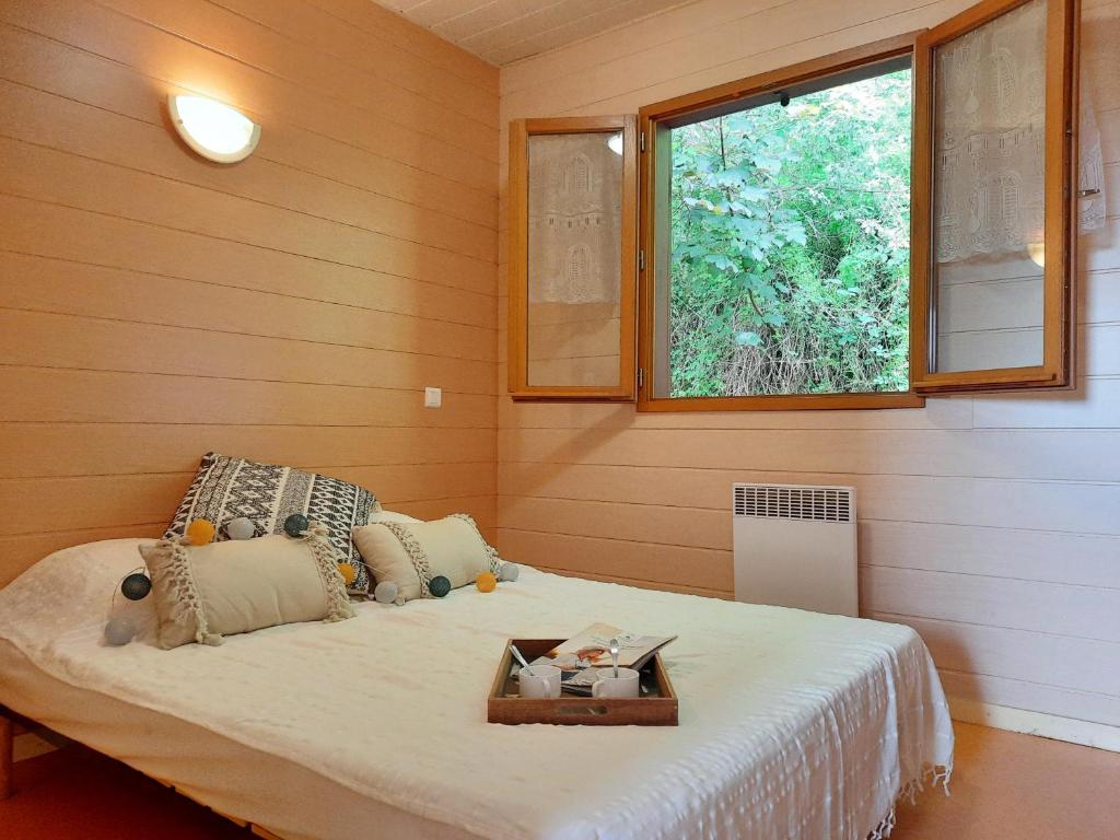 a bedroom with a bed with a tray on it at Camping de la Bageasse in Brioude