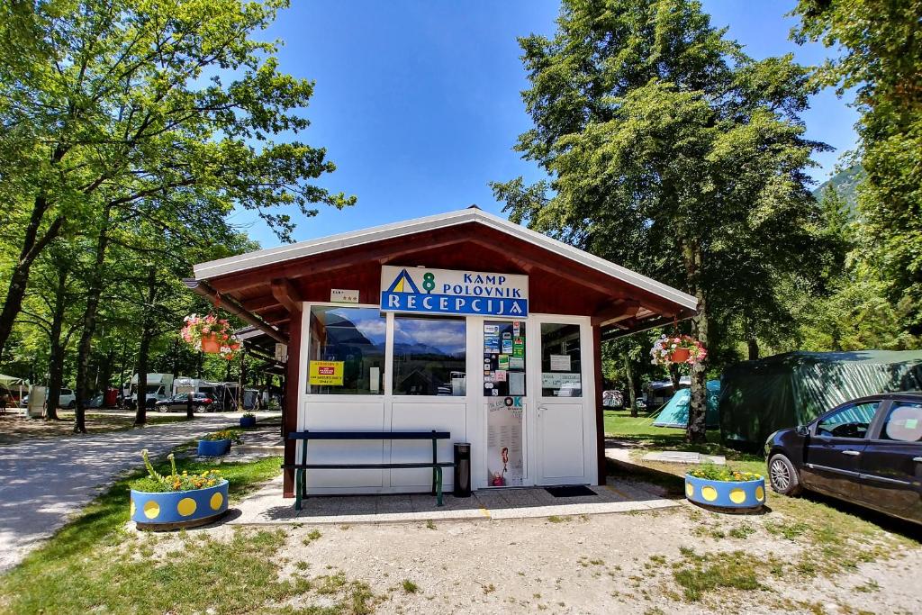 a gas station with a car parked next to it at Počitniška HIŠKA POLOVNIK in Bovec