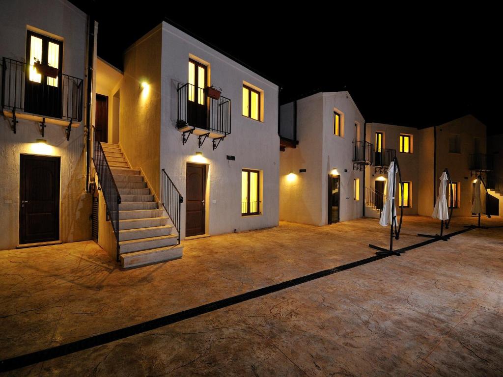 a courtyard of a building at night with lights at B&B Le Cale in Santa Maria Navarrese