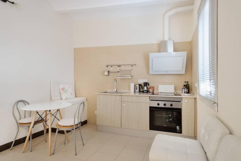 a kitchen with a table and a stove and a sink at Stay U-nique Apartments Pasteur in Barcelona