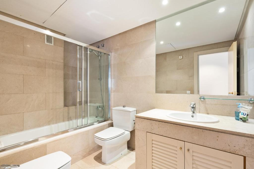 a bathroom with a toilet and a sink and a shower at Stay U-nique Apartments Passeig de Gracia II in Barcelona