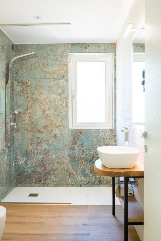 a bathroom with a sink and a window at Encanto Agriturismo & Private SPA in Visogliano