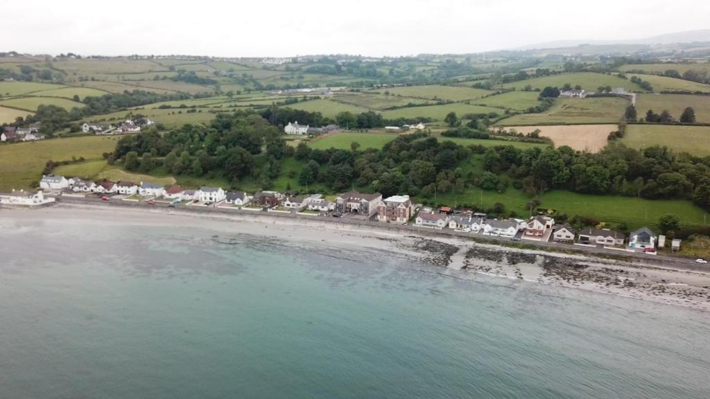 an aerial view of a beach with houses and the ocean at Bayview Apartments in Ballygalley
