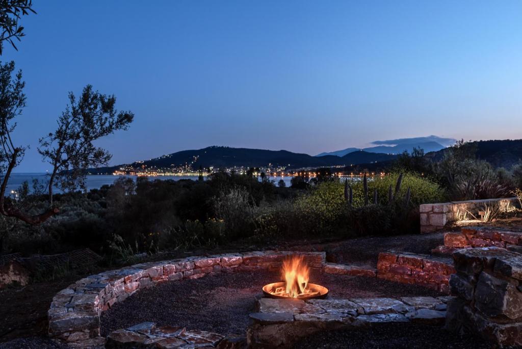 a fire pit in a yard at night at The Olive Yard in Gythio