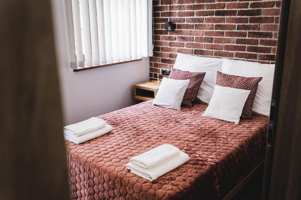Posteľ alebo postele v izbe v ubytovaní Apartamenty Świętego Jakuba