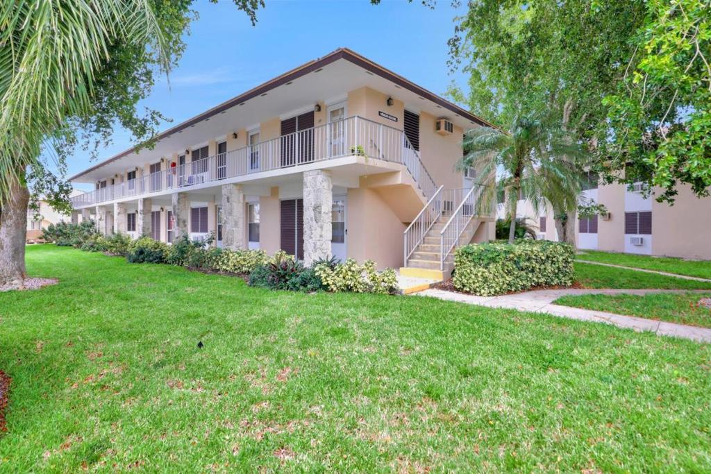 a large house with a lawn in front of it at Idyllic condo with brief walk to beach and restaurants in Marco Island
