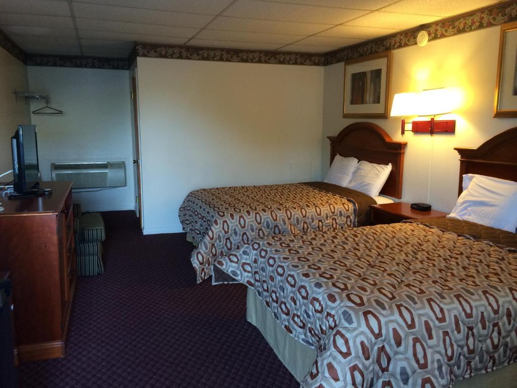 a hotel room with two beds and a television at Americas Best Value Inn - Palmyra/Hershey in Palmyra