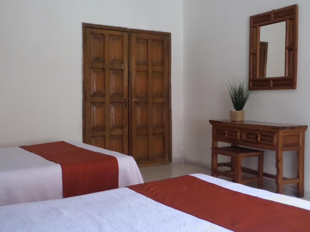 Postel nebo postele na pokoji v ubytování Hotel Casa de Vino