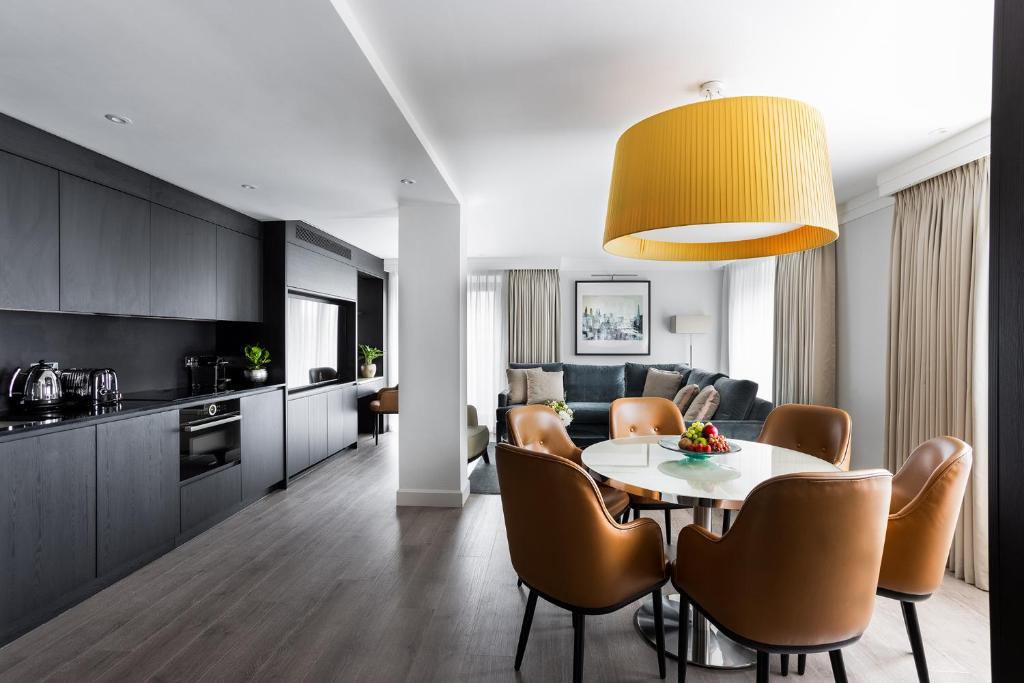 a kitchen and living room with a table and chairs at 15 Basil Street, Knightsbridge in London