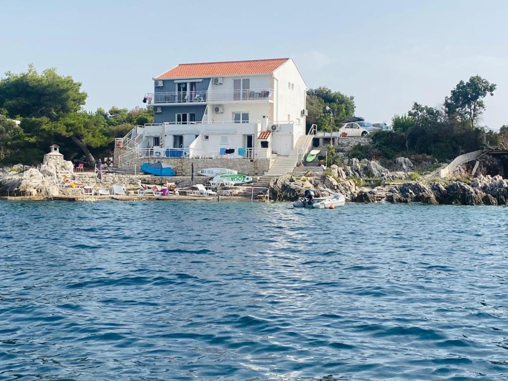 a house on the shore of a body of water at Apartment LEA - Amazing sea view in Sreser