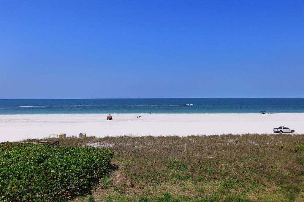 a beach with people on the sand and the ocean at Apollo 304 in Marco Island