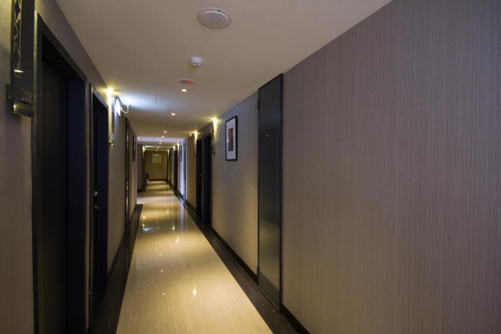 a hallway with a long aisle with lights on the walls at Royal Guest Hotel in Tainan