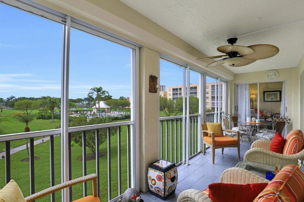 a screened in porch with a view of the ocean at Island-style condo with pool, spa and steps to beach in Marco Island
