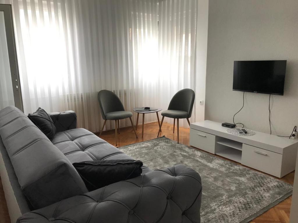 a living room with a couch and chairs and a television at Stan Na Dan in Novi Pazar