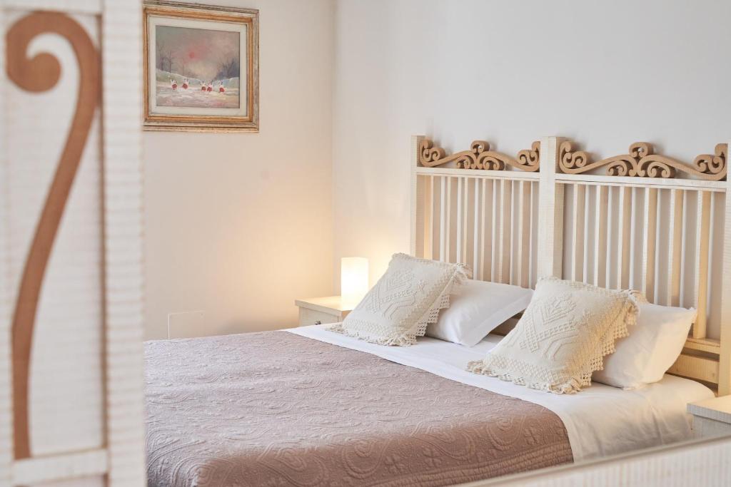 A bed or beds in a room at Affittacamere La Piazzetta