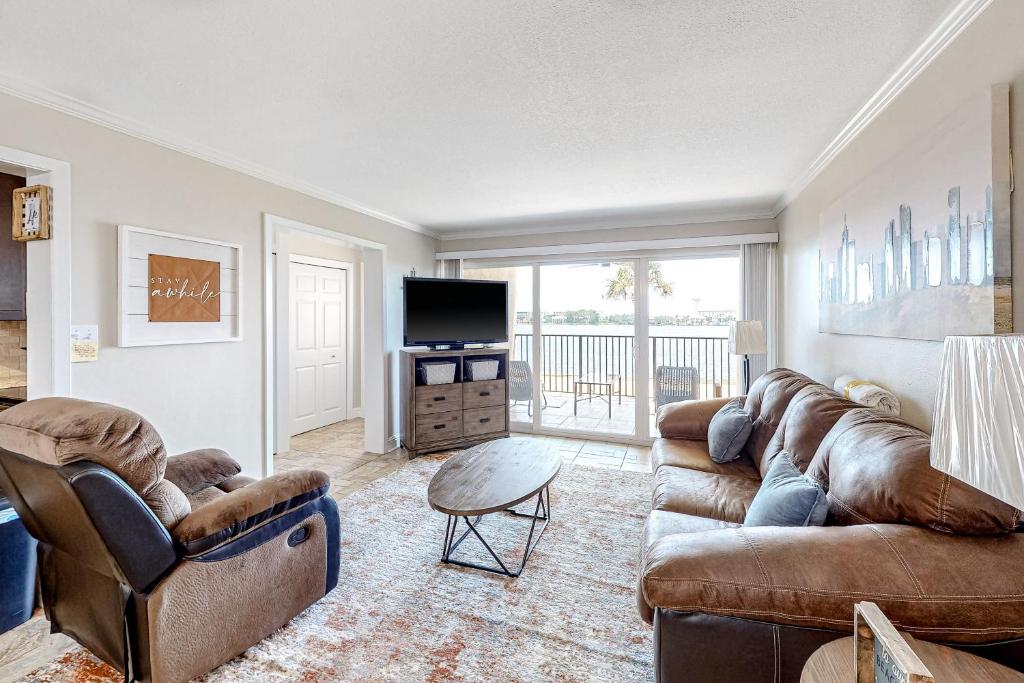a living room with two couches and a television at Sea Palms in Fort Walton Beach