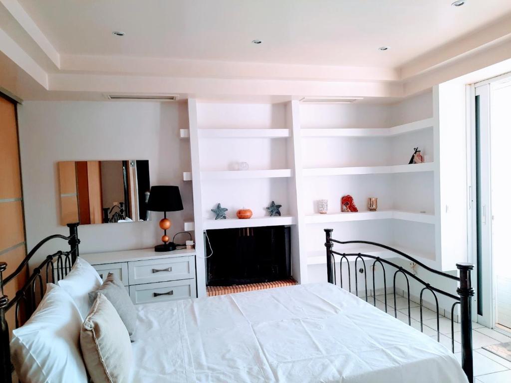 een slaapkamer met een bed en een open haard bij Ioannidis apartment in Psatha