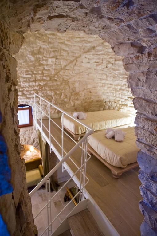 Postel nebo postele na pokoji v ubytování Le Alcove - Luxury Hotel nei Trulli