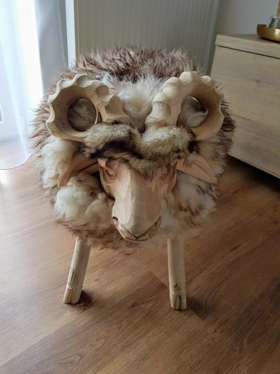 a stuffed animalanimal with legs on a wooden floor at Galeria Apartments - Jasná in Demanovska Dolina