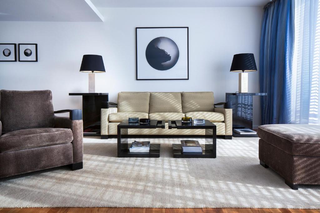 a living room with a couch and a coffee table at The Mandala Hotel in Berlin