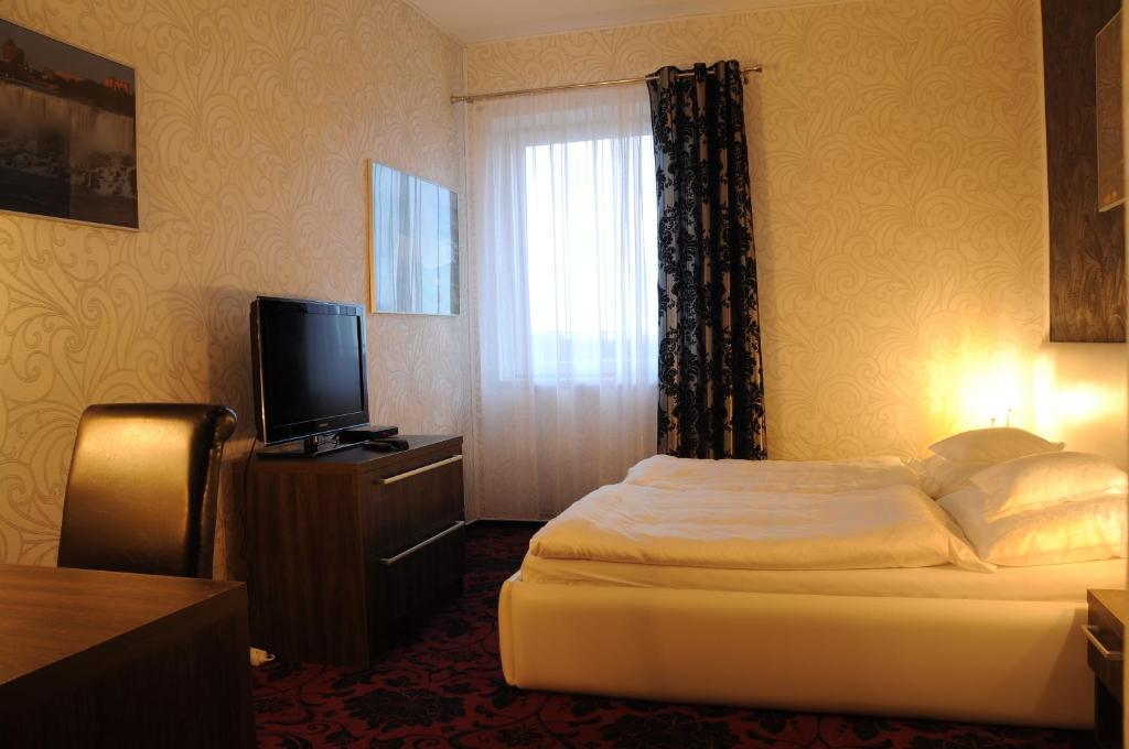 Postel nebo postele na pokoji v ubytování Restaurace a hotel Amerika