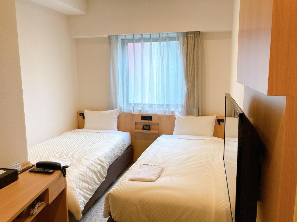 Postel nebo postele na pokoji v ubytování Nesthotel alt Kuramae Station