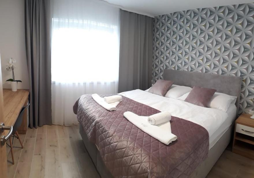 Postel nebo postele na pokoji v ubytování Apartmánový dům na kolonádě