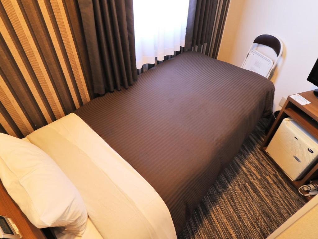 Postel nebo postele na pokoji v ubytování Odawara Terminal Hotel