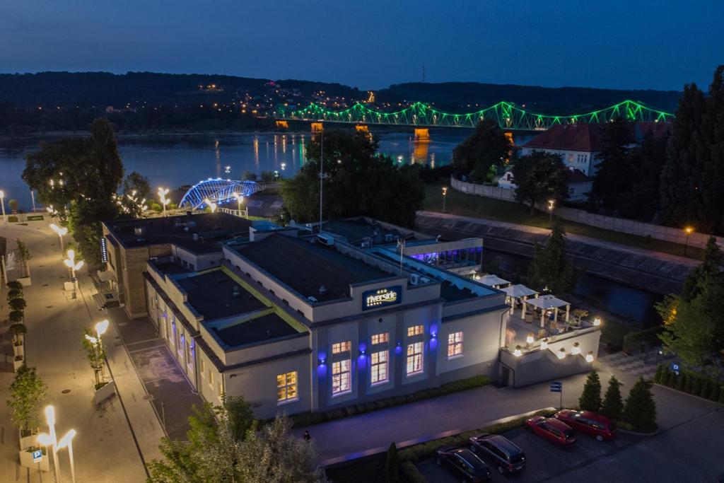 an overhead view of a building at night with a river at Riverside Hotel in Włocławek