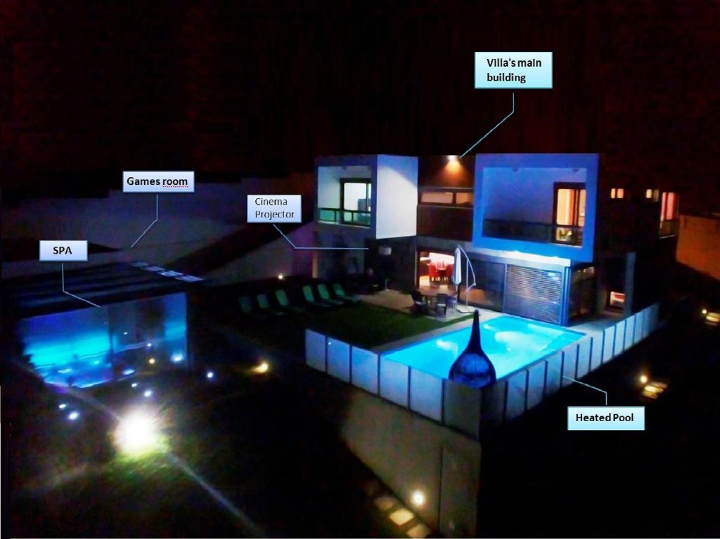 a night view of a house with a swimming pool at I Love U villa in Ericeira