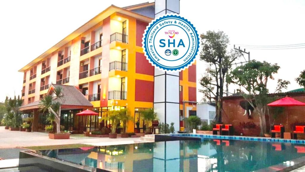 a hotel with a swimming pool in front of a building at Tawan Anda Garden Hotel in Suratthani