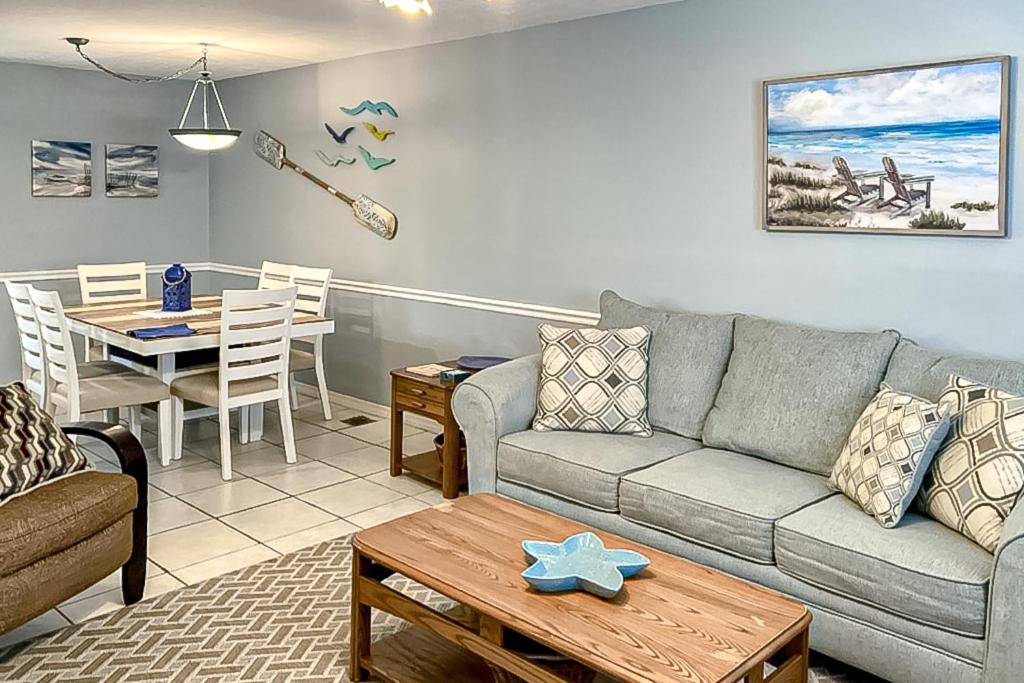 a living room with a couch and a table at Gulf Highlands - 173 Damon Circle in Panama City Beach