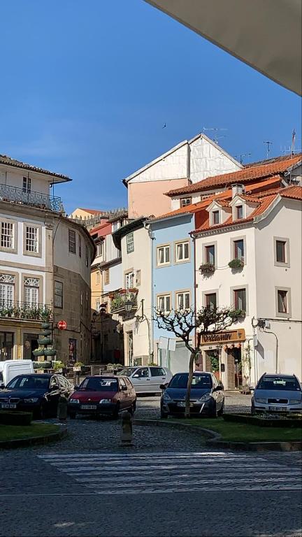 a group of cars parked in a parking lot at Vissaium Rooms- checkin até as 20h in Viseu