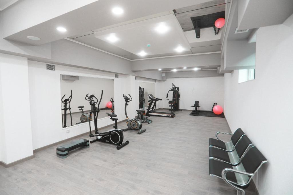 a gym with several treadmills and exercise bikes at Reikartz Amirun Tashkent in Tashkent