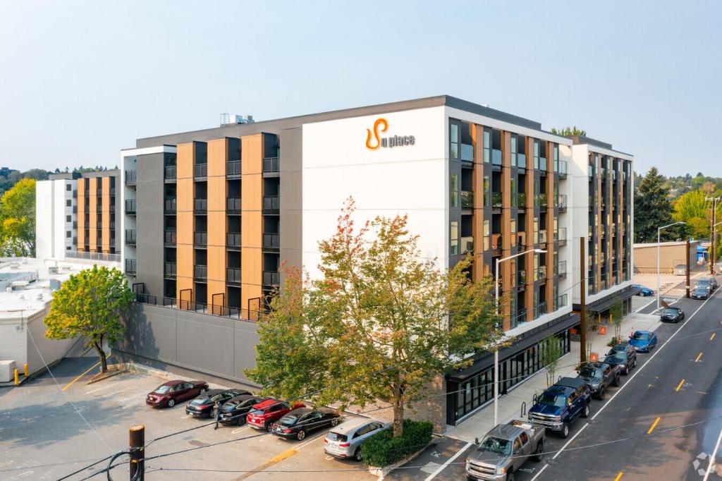 an office building with cars parked in a parking lot at University of Washington New Apartment Studio w/kitchen and balcony in Seattle