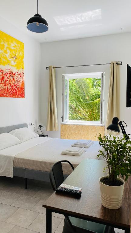 A bed or beds in a room at The Roof Garden - Bed&Breakfast