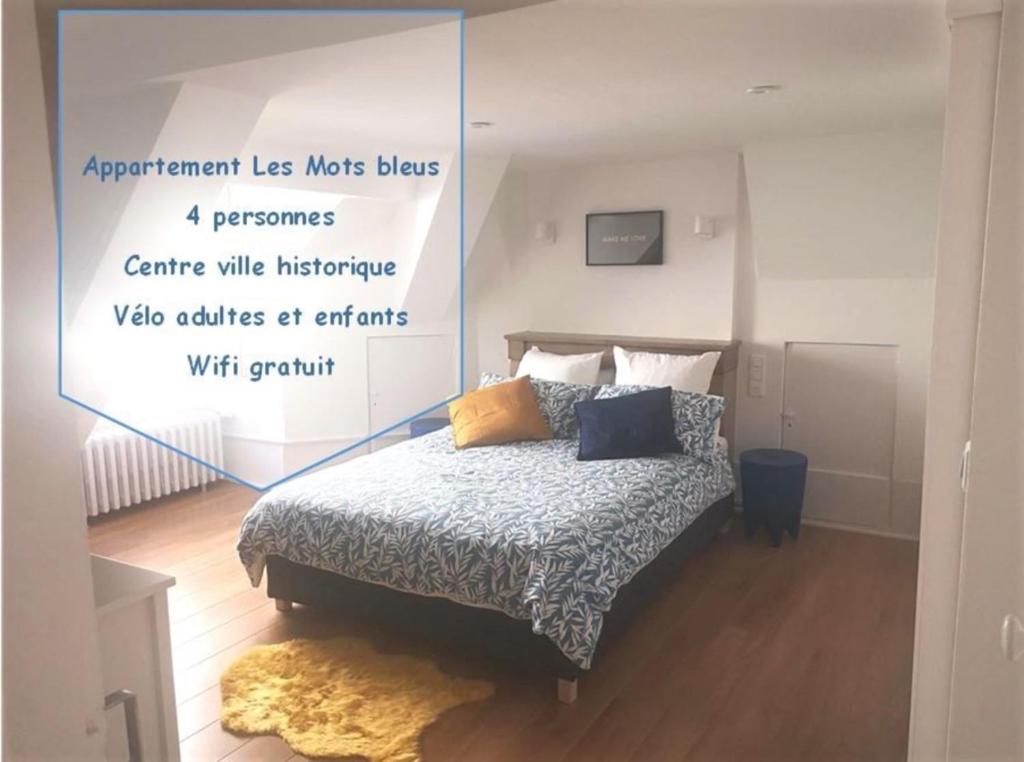 a bedroom with a bed with a poster on the wall at Centre ville historique - calme - les mots bleus in Besançon