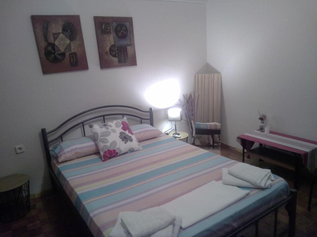 a bedroom with a bed and a table and a piano at Room to rent-shared wc in Kavála