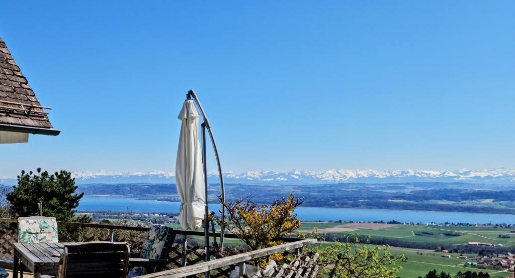 an umbrella on a balcony with a view of a lake at Mont Blanc Chalet in Grandevent