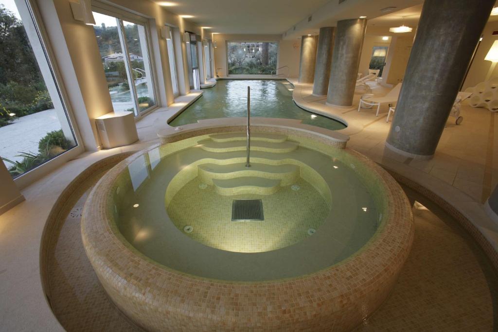 a jacuzzi tub in a large building with columns at Villa Maria Hotel & SPA in Francavilla al Mare