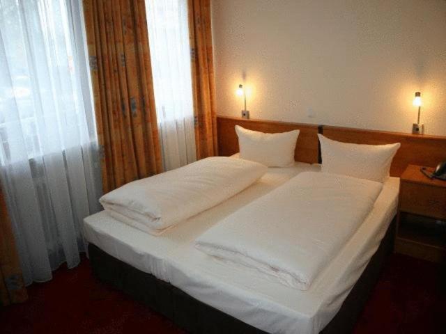 Postel nebo postele na pokoji v ubytování Hotel Accolo