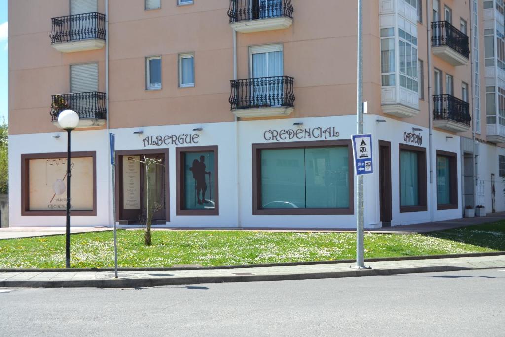 a building with windows on the side of a street at Albergue Credencial in Sarria