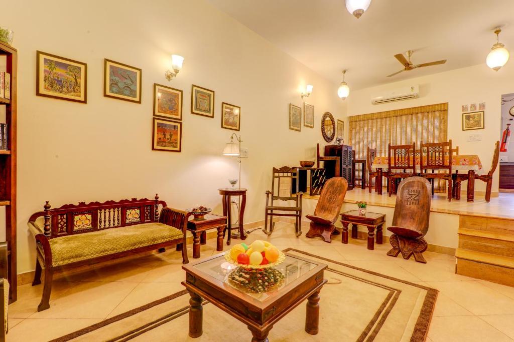 a living room filled with furniture and a table at Heritage Nirvana Villa - 4BHK, Goa in Calangute