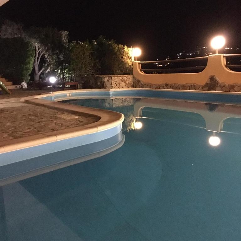 The swimming pool at or close to VILLA VITTORIA with PRIVATE HEATED SWIMMING POOL COMPLETE WITH HIDROMASSAGE FOR EXCLUSIVE USE , SEA VIEW, 150 METERS FROM THE BEACH