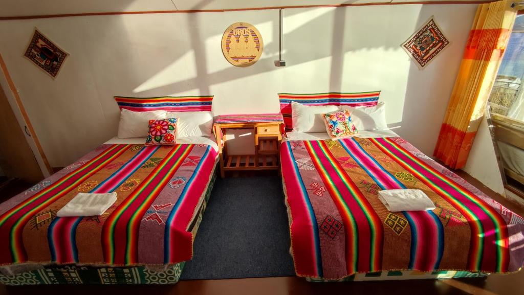 Postel nebo postele na pokoji v ubytování Titicaca Aruntawi Lodge Peru
