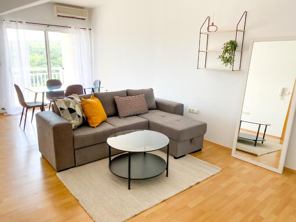 a living room with a couch and a table at Maslina Apartments in Široki Brijeg