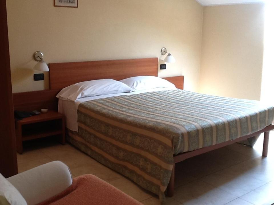 Postel nebo postele na pokoji v ubytování CerrutiHotel