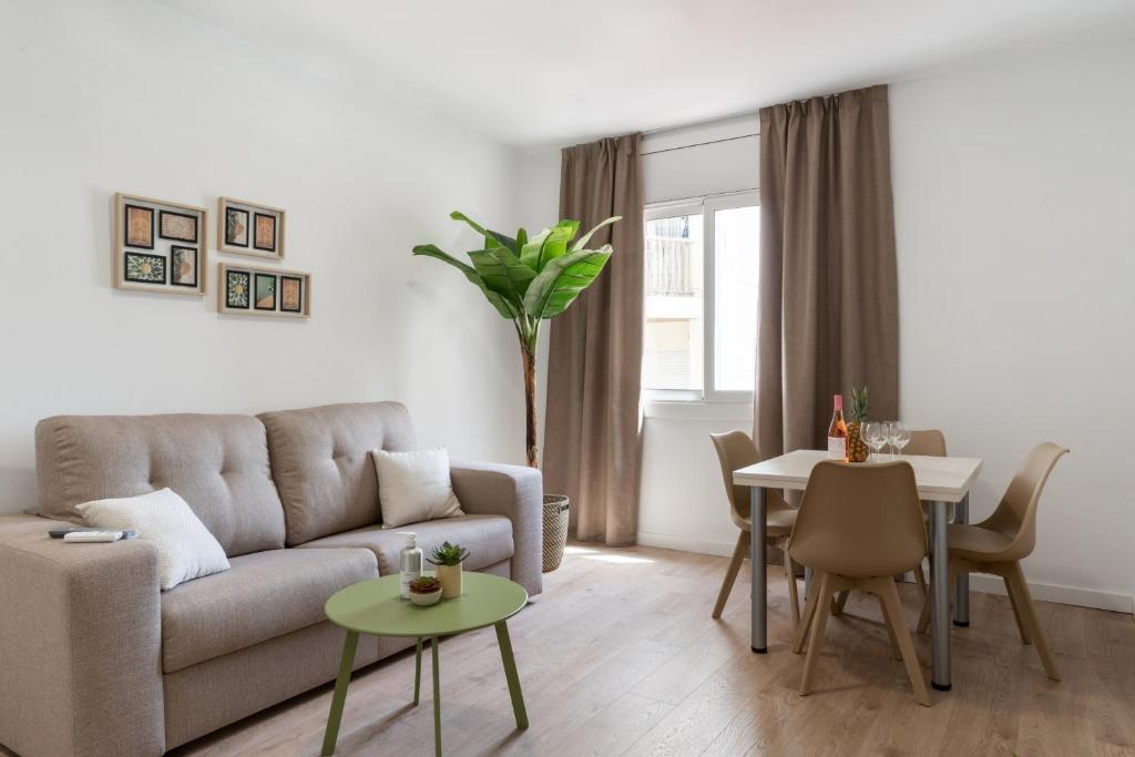a living room with a couch and a table at Apartamentos Venecia in Lloret de Mar